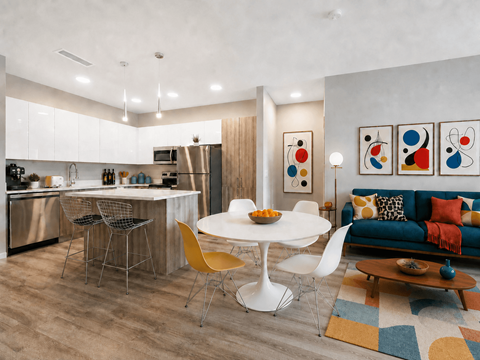 A modern kitchen with a dining table and chairs.