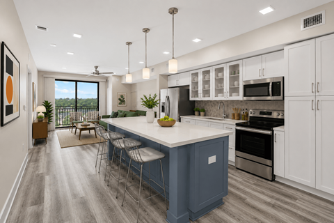 A modern kitchen with a blue island and white cabinets.