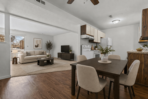 A modern dining room with a wooden table and chairs.