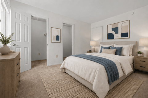 A bedroom with a large bed and a wooden dresser.