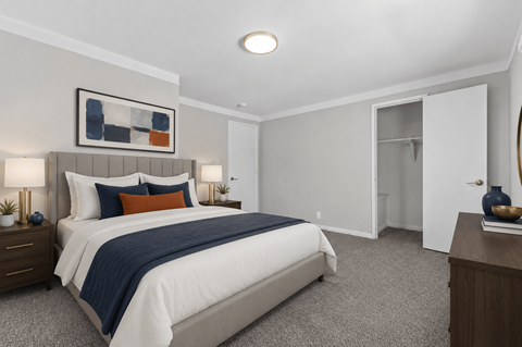 A bedroom with a large bed and a painting on the wall.