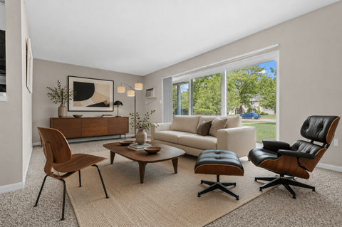 A living room with a brown chair and a brown coffee table.