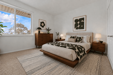 A bedroom with a large bed and a window.