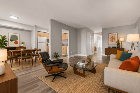 A modern living room with a black chair and a glass coffee table.