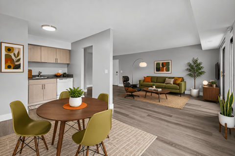 A modern dining room with a round table and chairs.