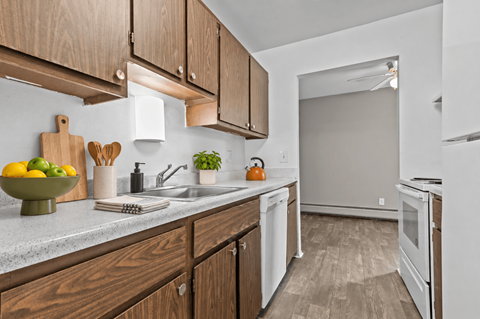 A kitchen with wooden cabinets and white appliances.