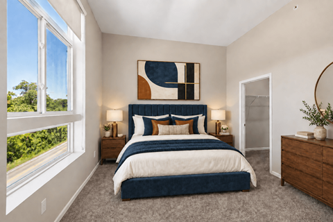 A bedroom with a large bed and a painting on the wall.