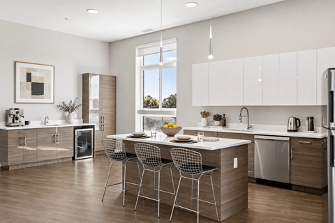 A modern kitchen with a dining table and chairs.