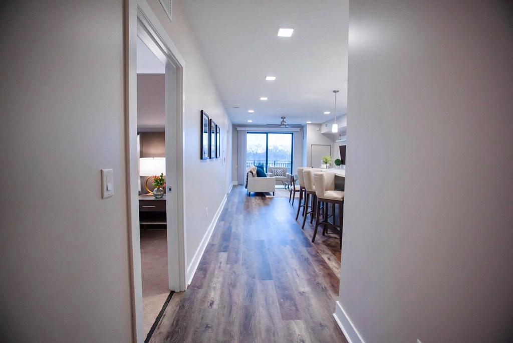 a view of a living room and dining room from the hallway of a house