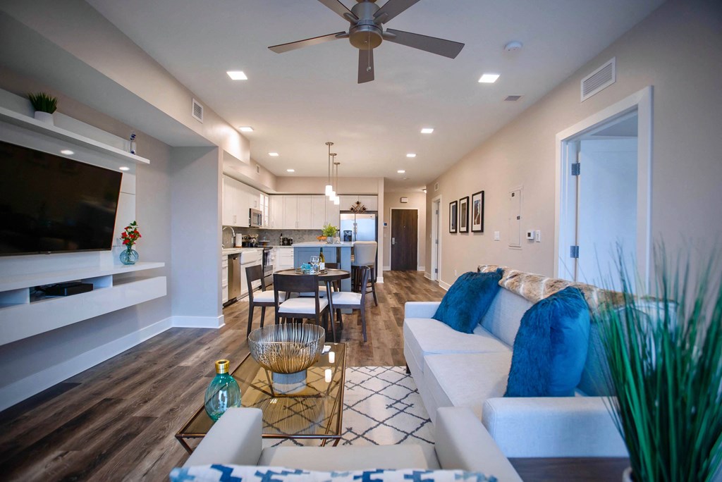 a living room with a couch and a ceiling fan