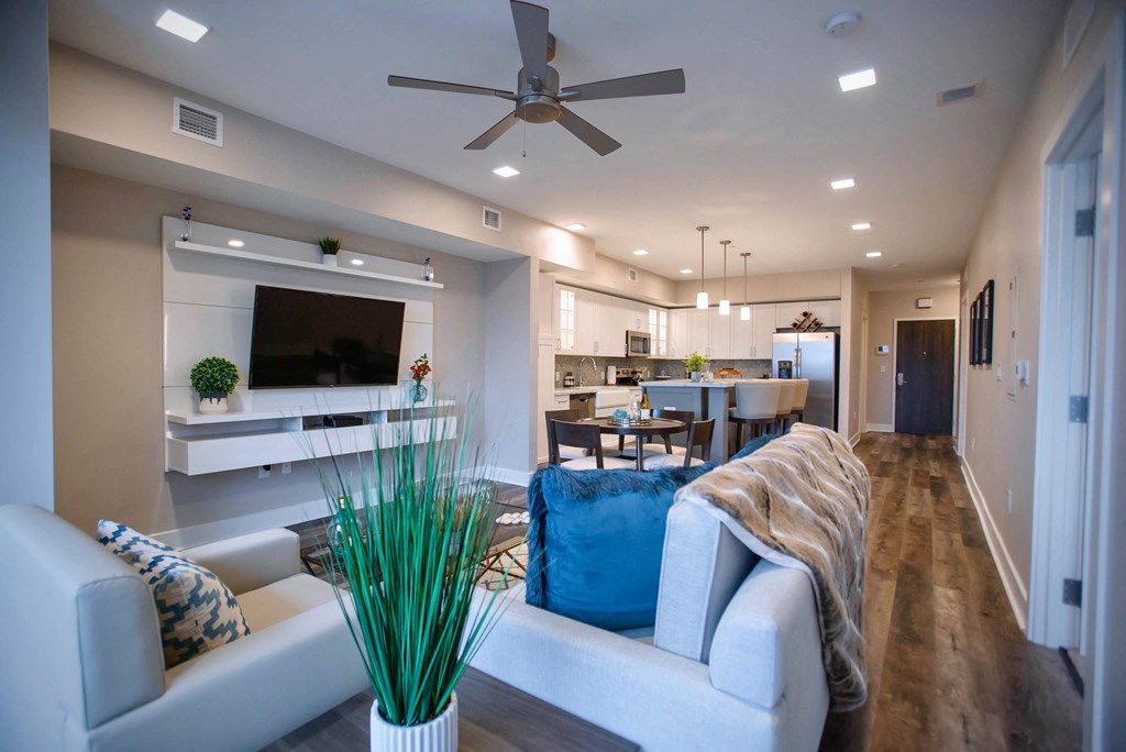 a living room with a couch and a ceiling fan