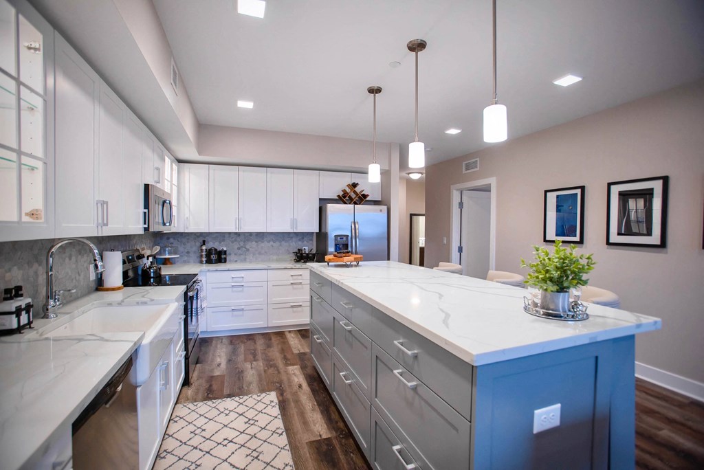 a large kitchen with white cabinets and white counter tops