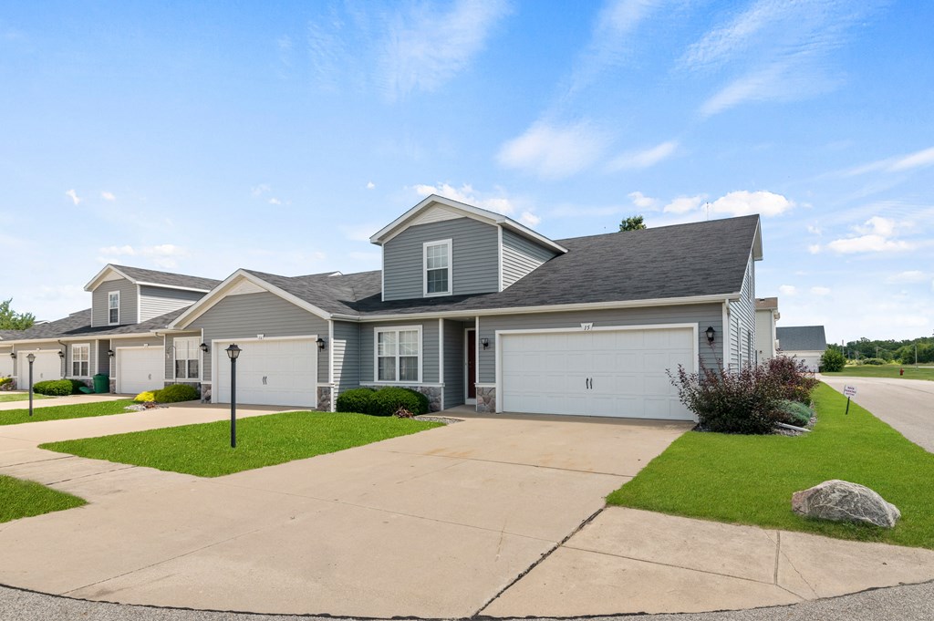 a house with a driveway and a garage door in front of it