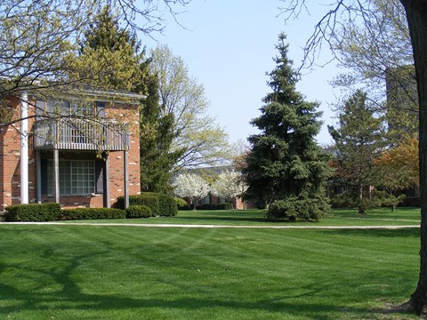 a lawn in front of a brick building
