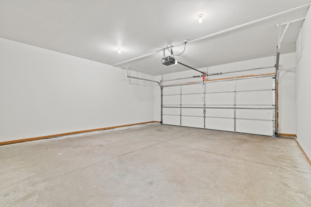 a white garage with a white wall and white garage doors