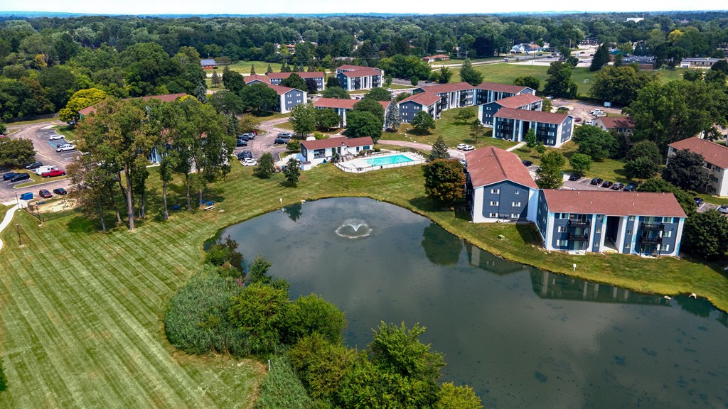 A bird's eye view of a resort with a lake and buildings.