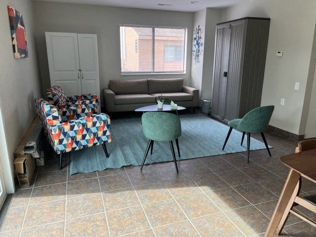 a living room with a couch and a table and chairs