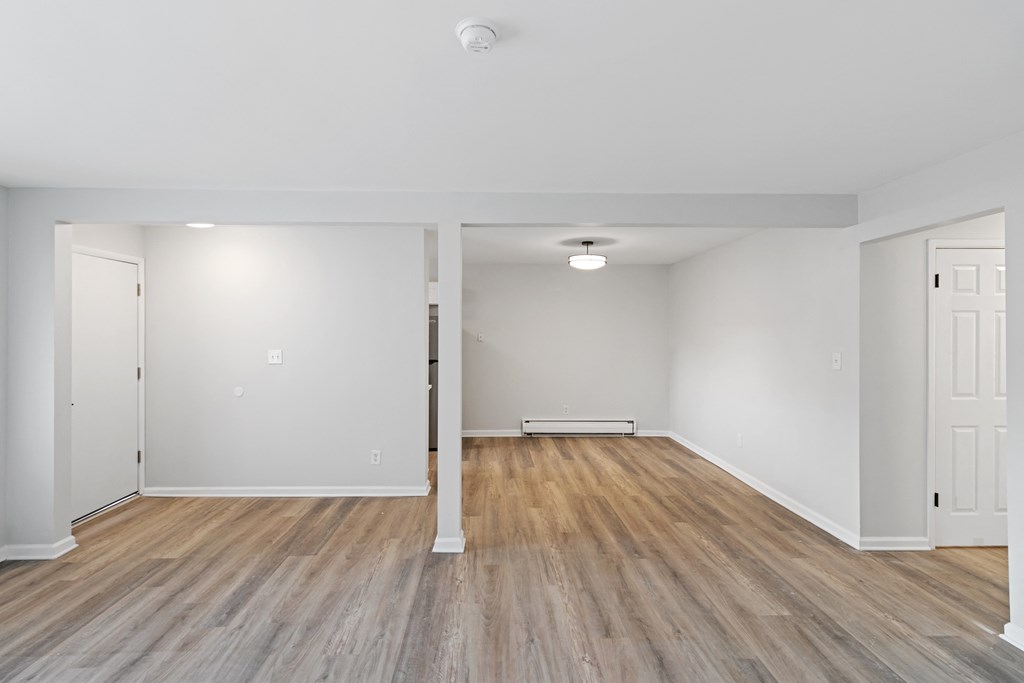 A room with wooden floors and white walls.