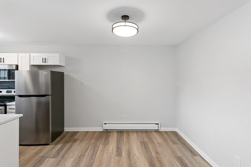 A kitchen with a refrigerator, stove, and oven.