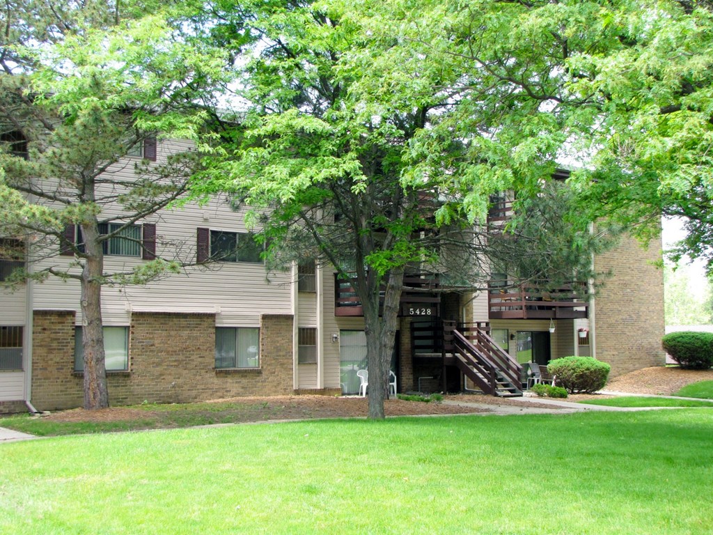 our apartments have a large green lawn and trees