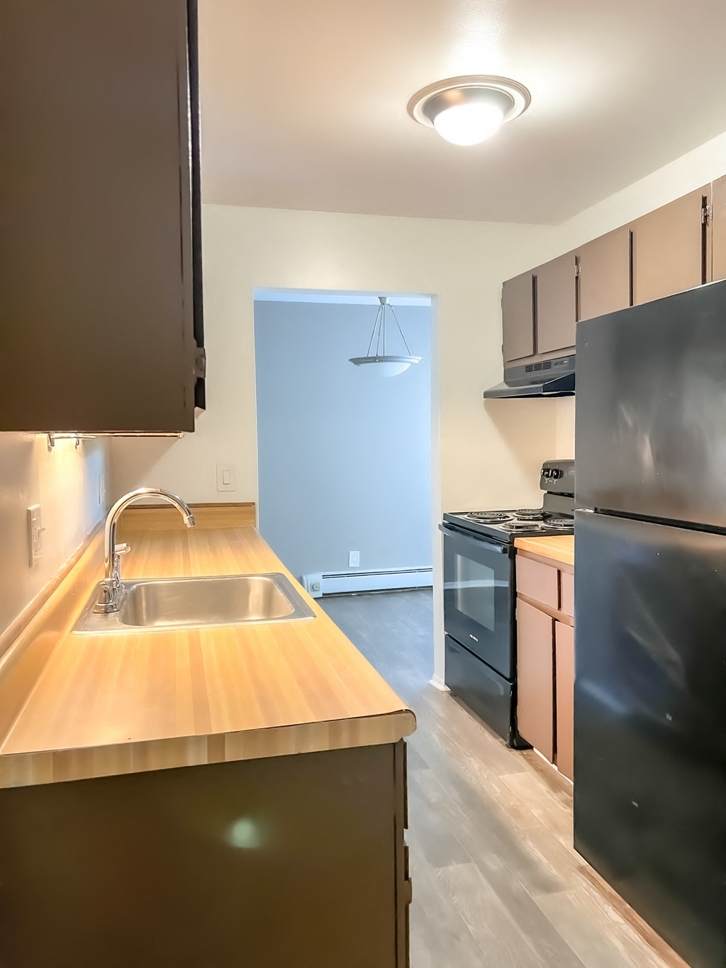 a kitchen with wood countertops and black appliances