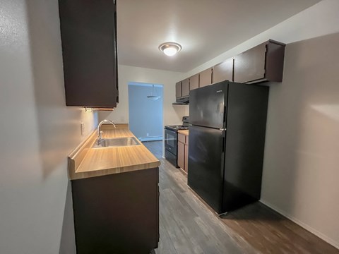 a kitchen with a blue refrigerator freezer next to a stove top oven