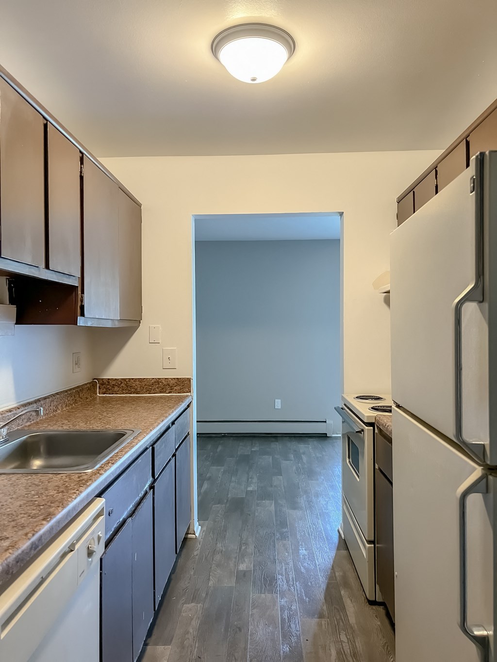 a kitchen with white appliances and blue cabinets