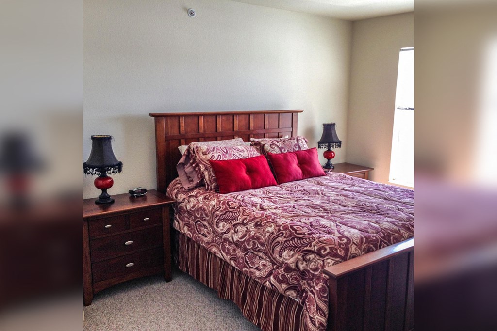 a bedroom with a bed and two night stands