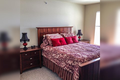 a bedroom with a bed and two night stands
