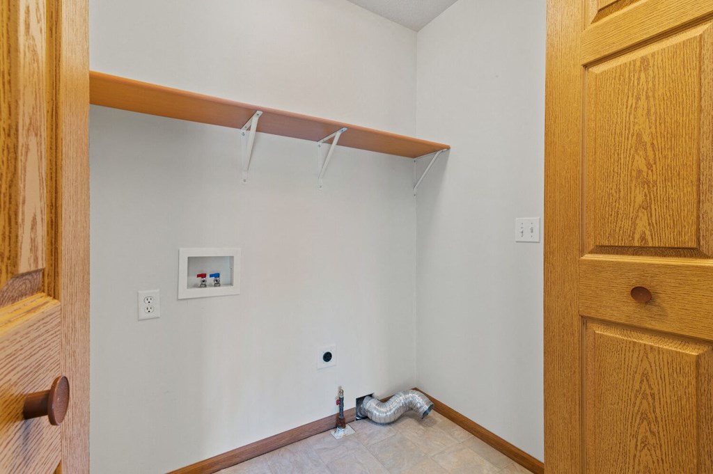 a room with white walls and a closet and a door