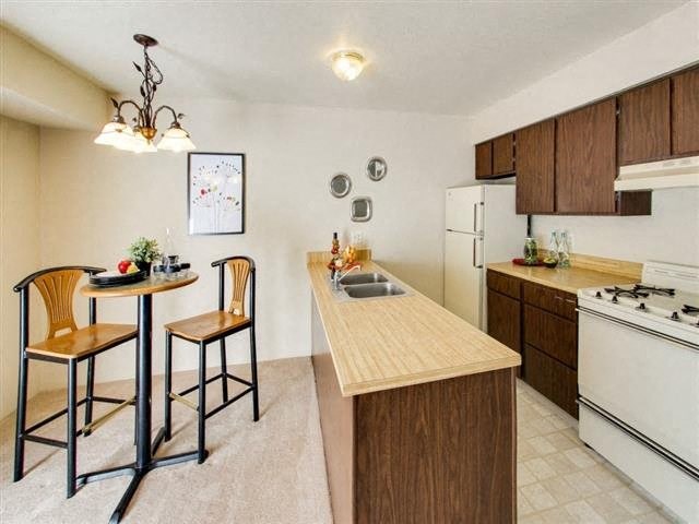 a kitchen with a bar and a kitchen table