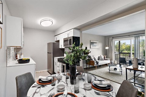 a kitchen and living room with a table and chairs