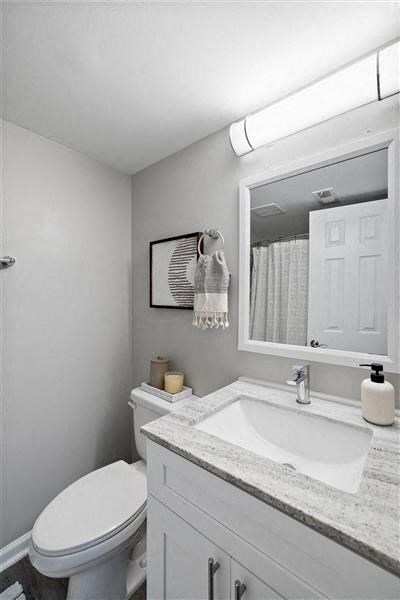 a bathroom with a sink toilet and a mirror