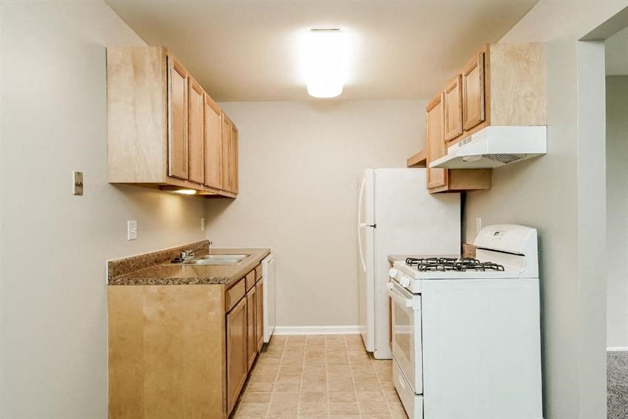 a kitchen with a stove and a refrigerator