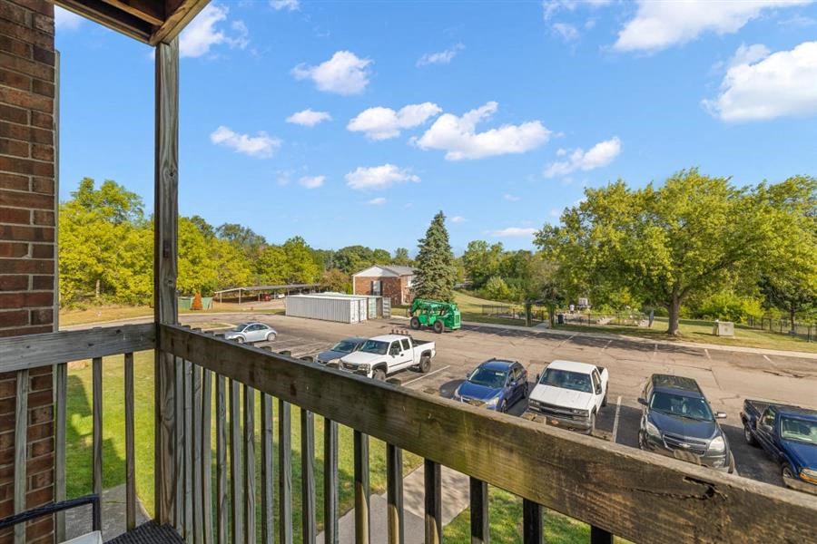 the view of the parking lot from the porch of a house