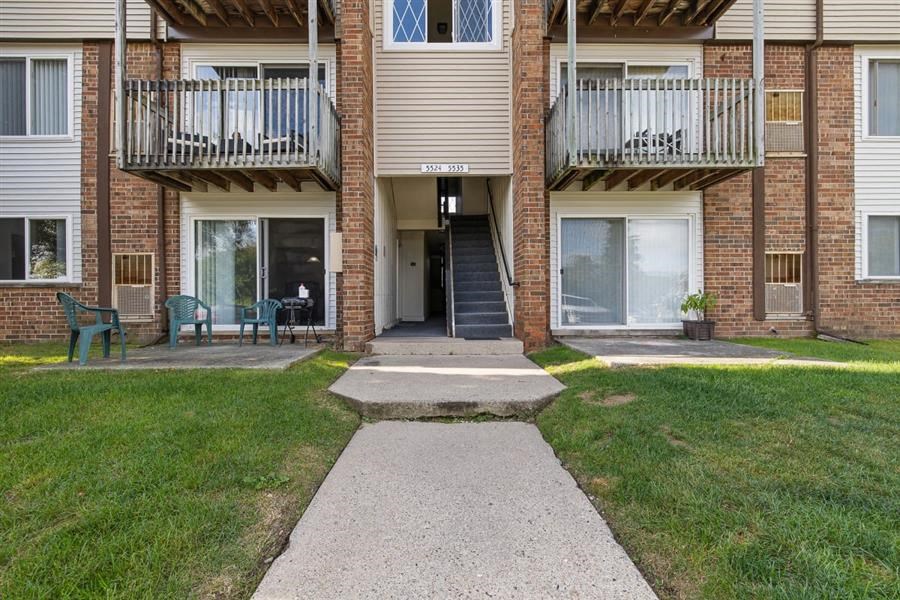 a walkway in front of a brick building