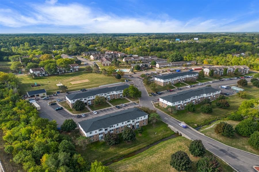 an aerial view of a city with buildings and trees