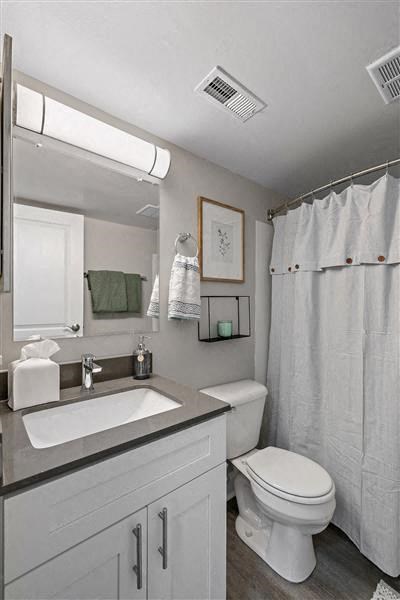 a white bathroom with a toilet and a sink