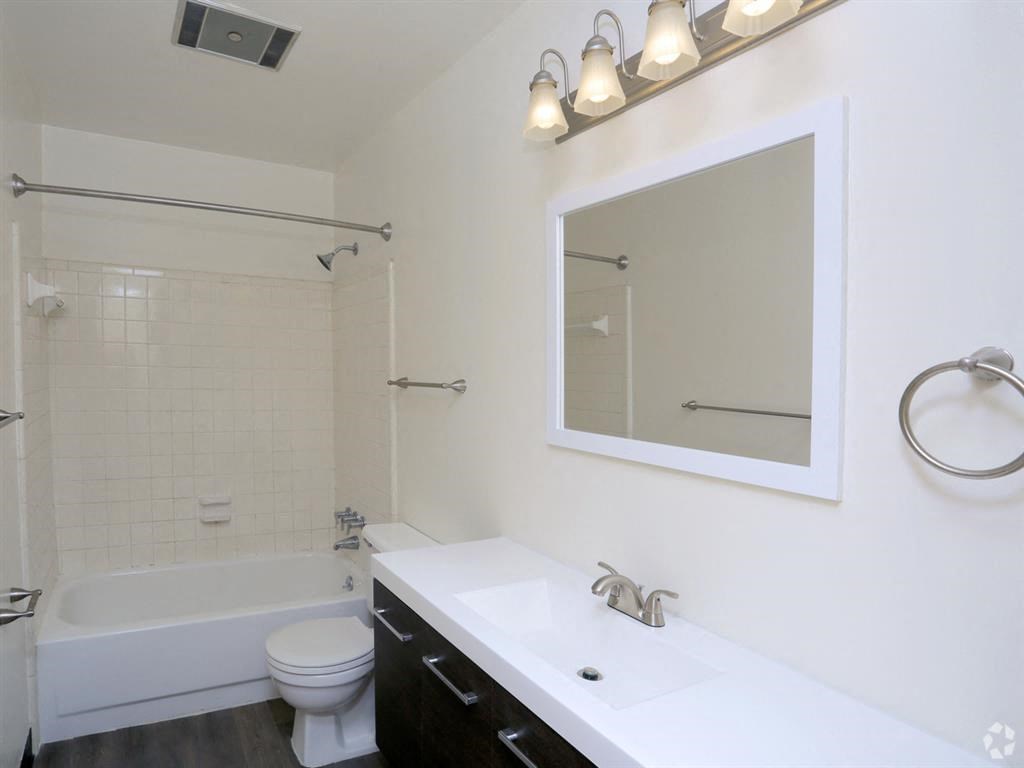 a bathroom with a sink toilet and bathtub