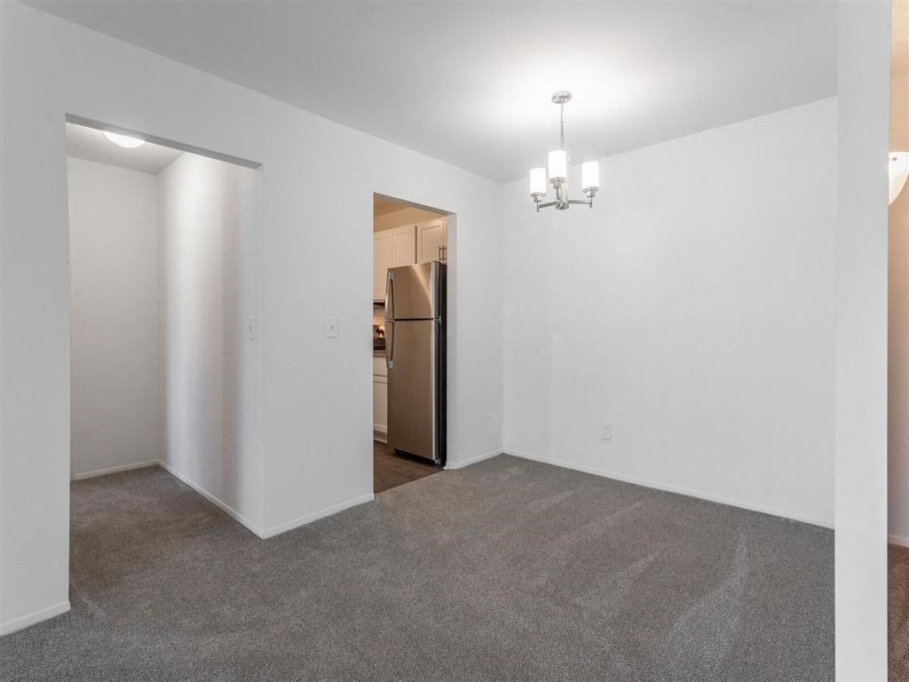 an empty room with a refrigerator in it