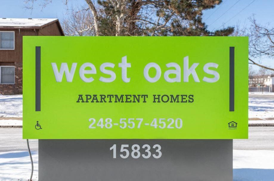 a sign for west oaks apartment homes