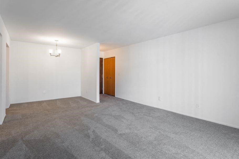 an empty room with white walls and a door