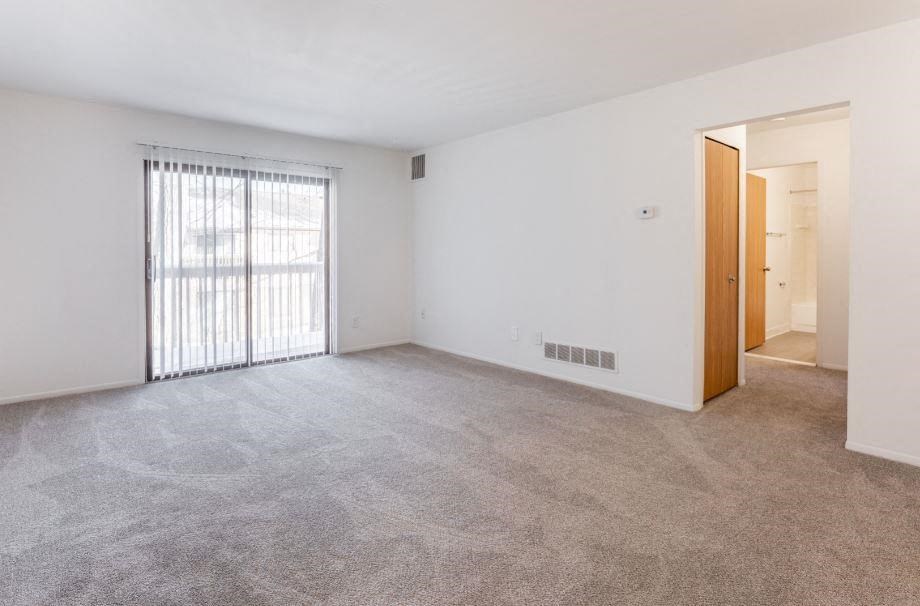 an empty living room with a sliding glass door