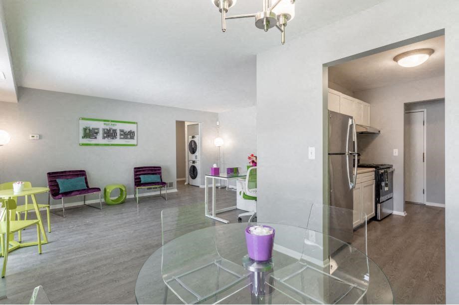 a living room with a glass table and chairs