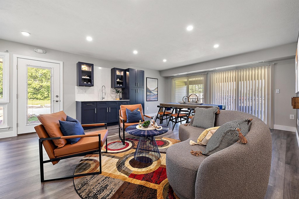 a living room with a couch and a table at Sunnymede Apartments - Troy, MI, Michigan
