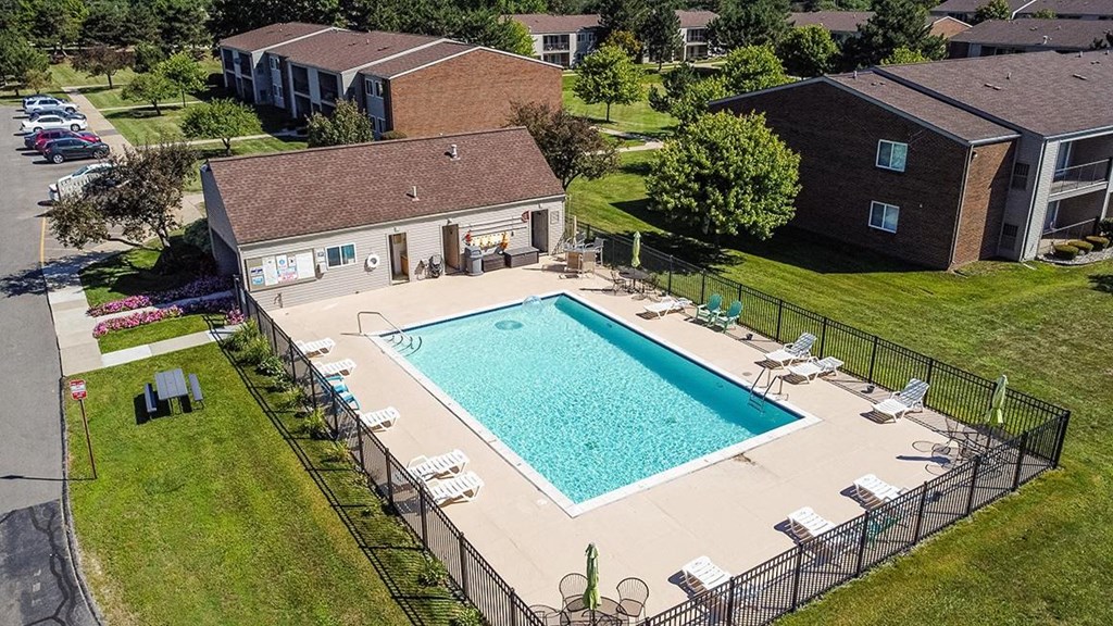 an aerial view of a swimming pool in front of a house at Sunnymede Apartments - Troy, MI, Michigan