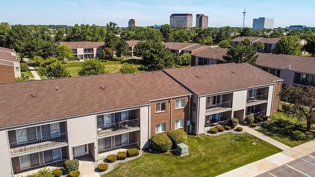 an aerial view of an apartment building with grass and trees at Sunnymede Apartments - Troy, MI, Troy, Michigan
