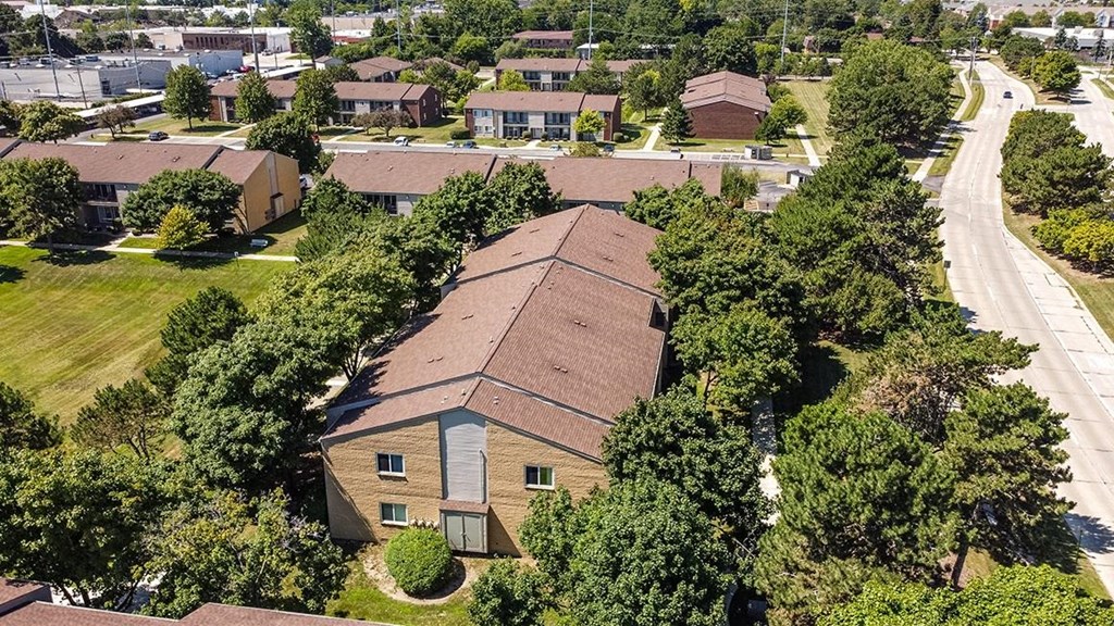 an aerial view of a house in a neighborhood with trees at Sunnymede Apartments - Troy, MI, Troy, Michigan