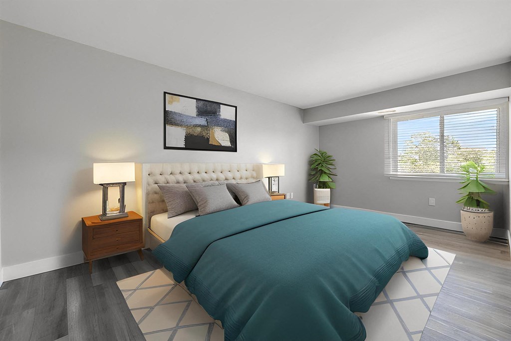 a bedroom with a bed and a window at Sunnymede Apartments - Troy, MI, Michigan