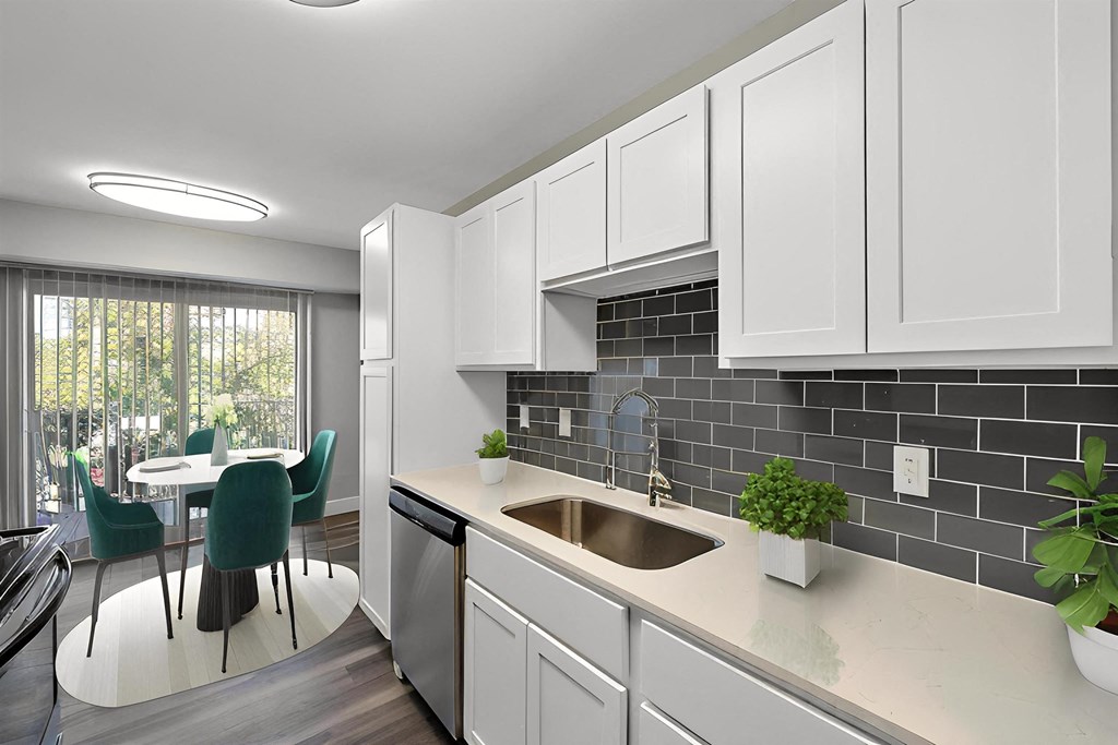 a kitchen with white cabinets and a sink at Sunnymede Apartments - Troy, MI, Troy, Michigan
